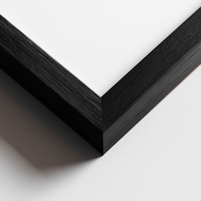 Close-up of a black wooden picture frame corner on a white background